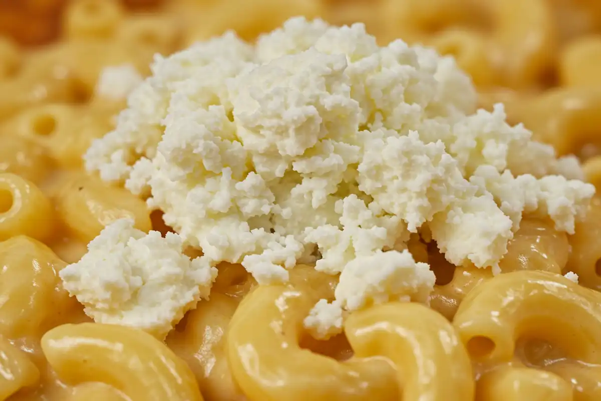 Crumbled feta on mac and cheese - an example of "What cheeses are not to use for mac and cheese," showing poor melting and texture.